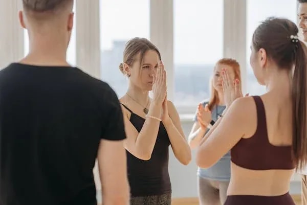 Yoga instructor teaching students balance and core poses in a studio